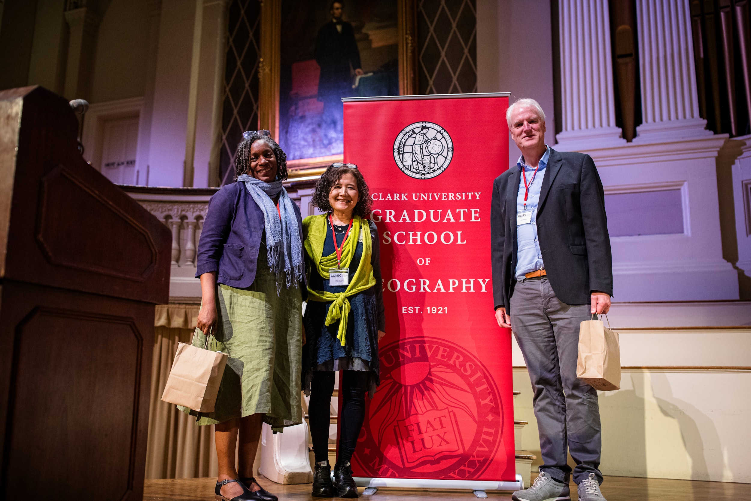 Beverley Mullings, Yuko Aoyama, Ron Boschma pose on stage