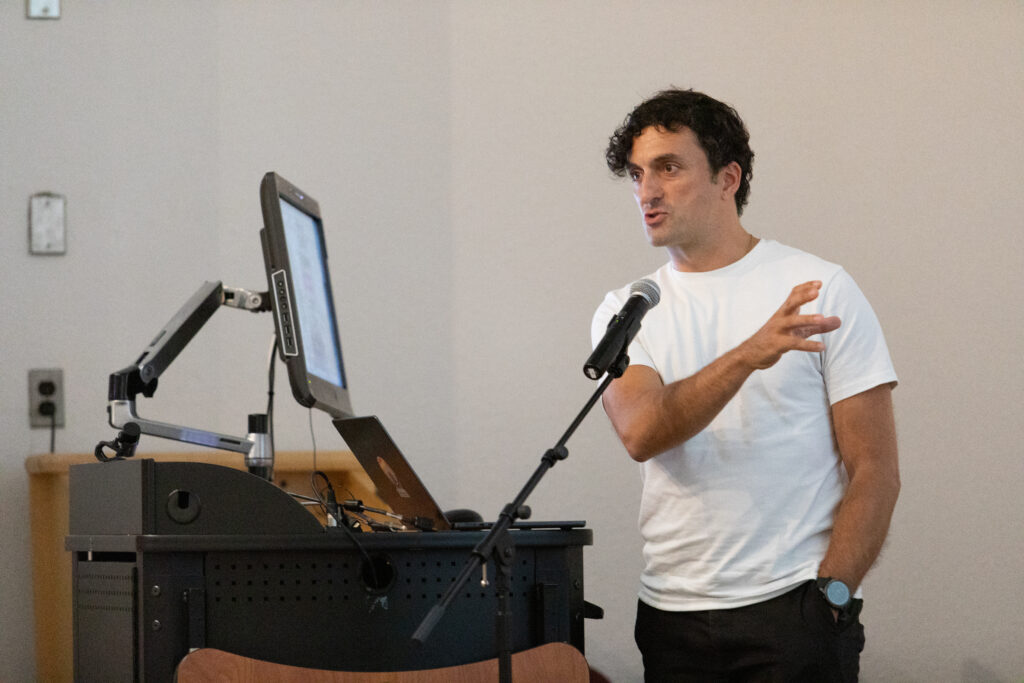 man at microphone and computer