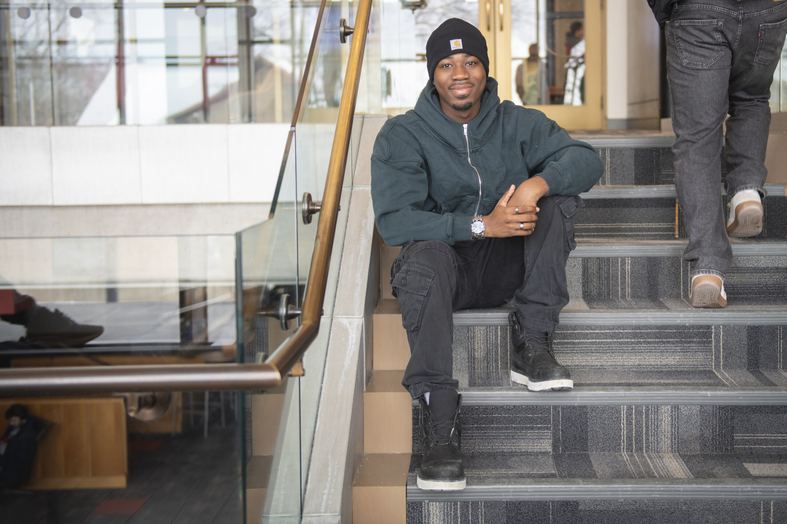 student sits on stairs