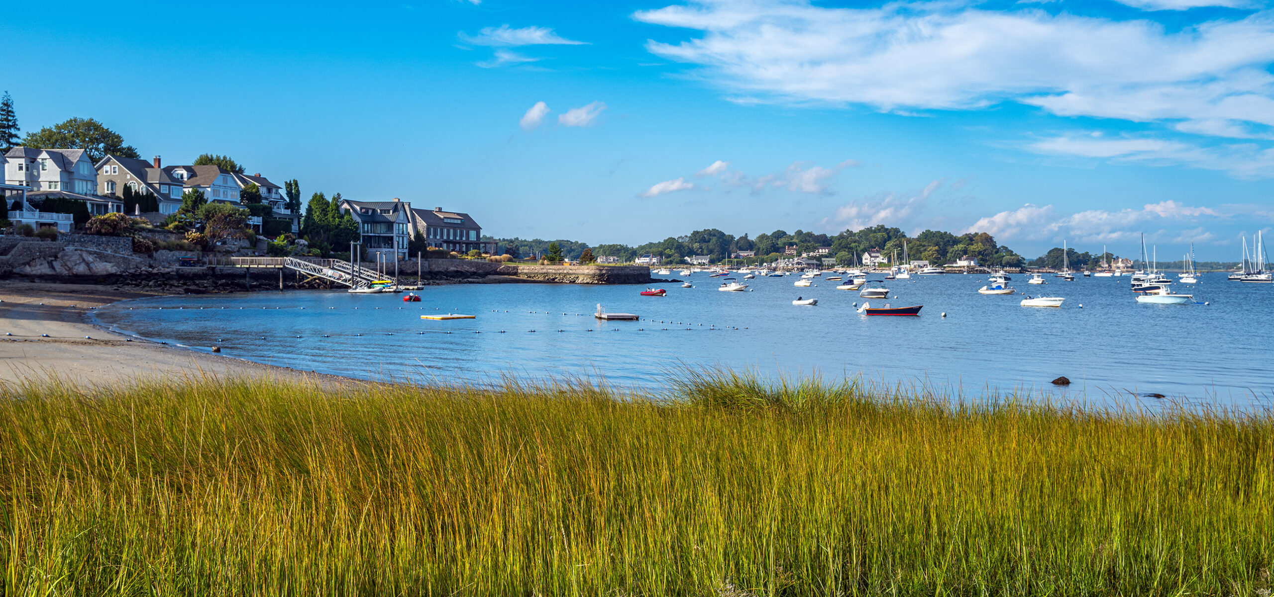 Scenic view of shoreline with houses along Long Island Sound