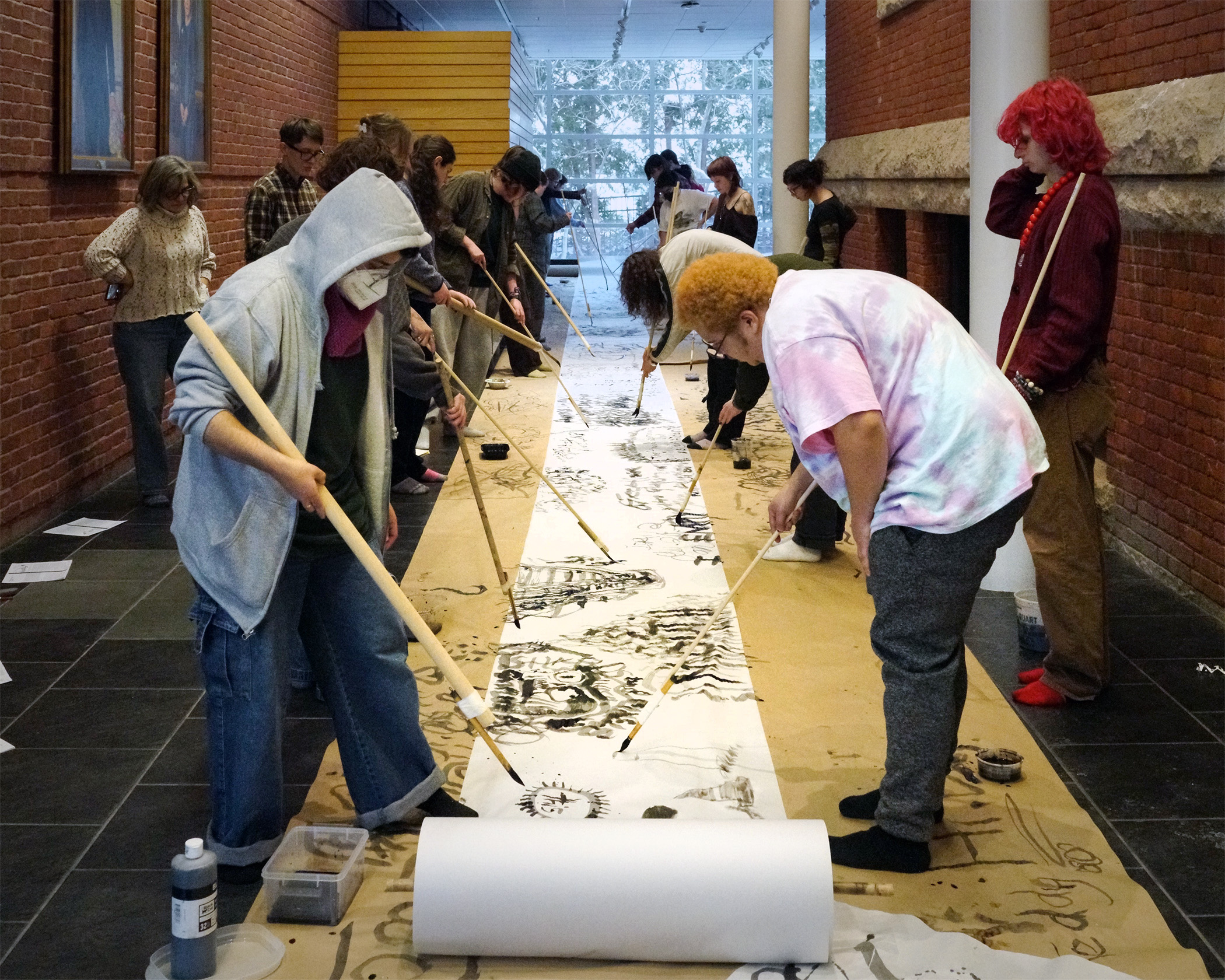 students make calligraphy art on scroll