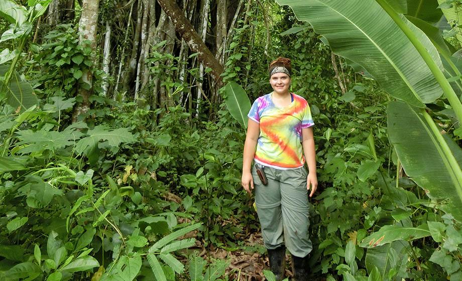 student standing in rain forest