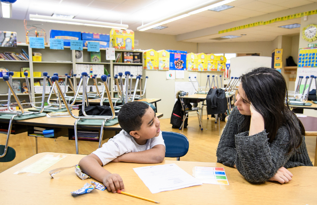 College student helping elementary school student