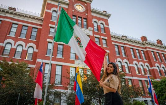 Clark student with flag of Mexico