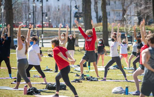 Students doing yoga on the commons