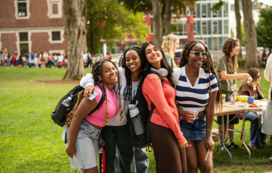 a photo of four women grouped together and smiling