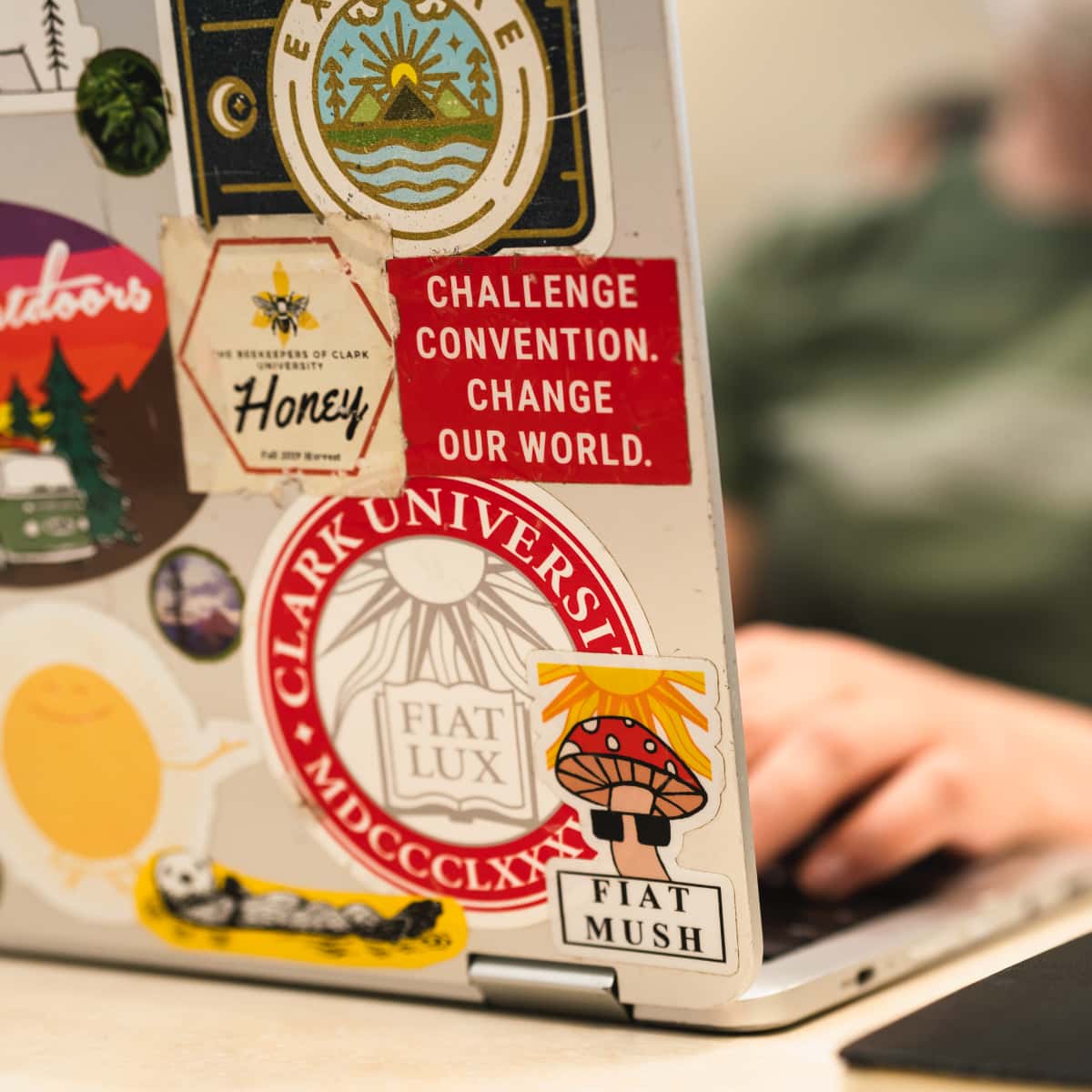 a laptop decorated with ClarkU stickers