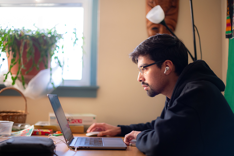 student working behind laptop