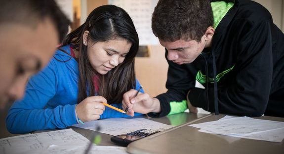 young students writing in their books