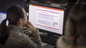 A woman prepares a digital presentation