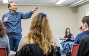Spanish professor talking to professor students in classroom