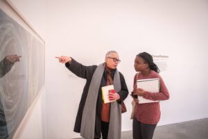 Visual and performing arts professor Toby Sisson points out a detail to a student during a visit to the ICA, Boston