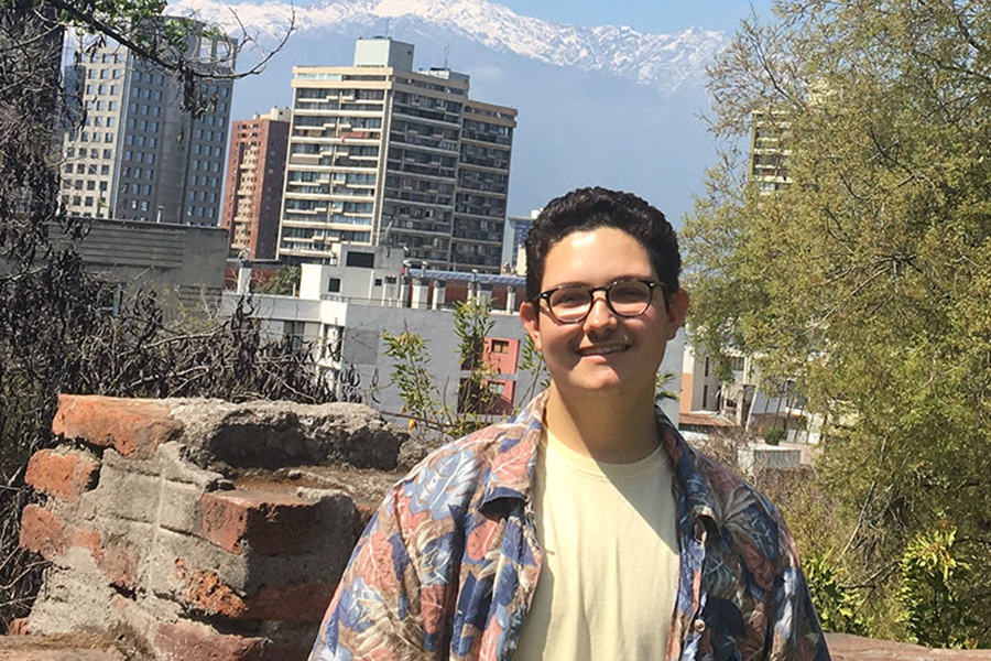 student with city behind him