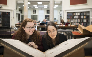 Students looking over newspaper archives