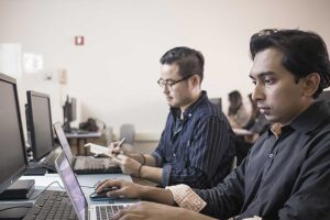 Accounting students work at the computer together