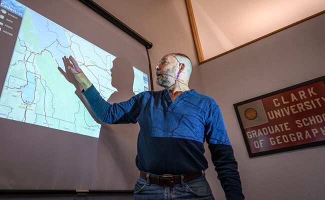 Professor pointing at slideshow