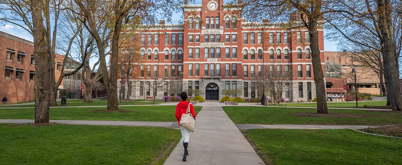 assumption transfer - student walking up path to Jonas Clark buil
