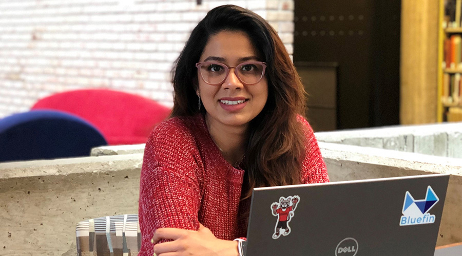 woman at laptop in library during summer session