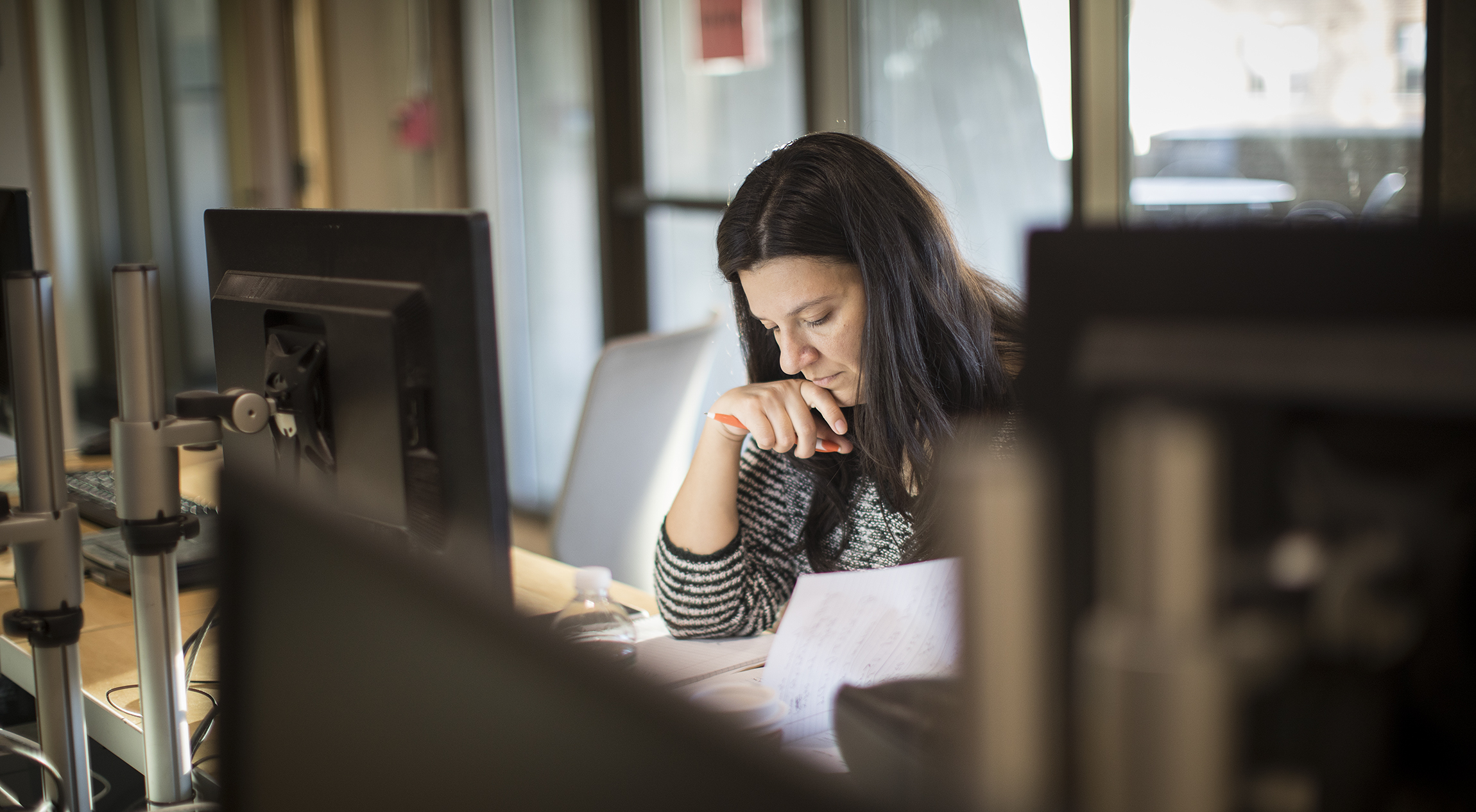 female student looking over paperwork for professional studies