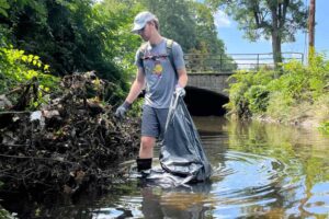 A student cleans up Beaver Brook