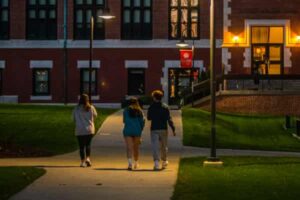 student walking across campus in the evening