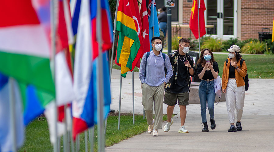 Students walking near flags