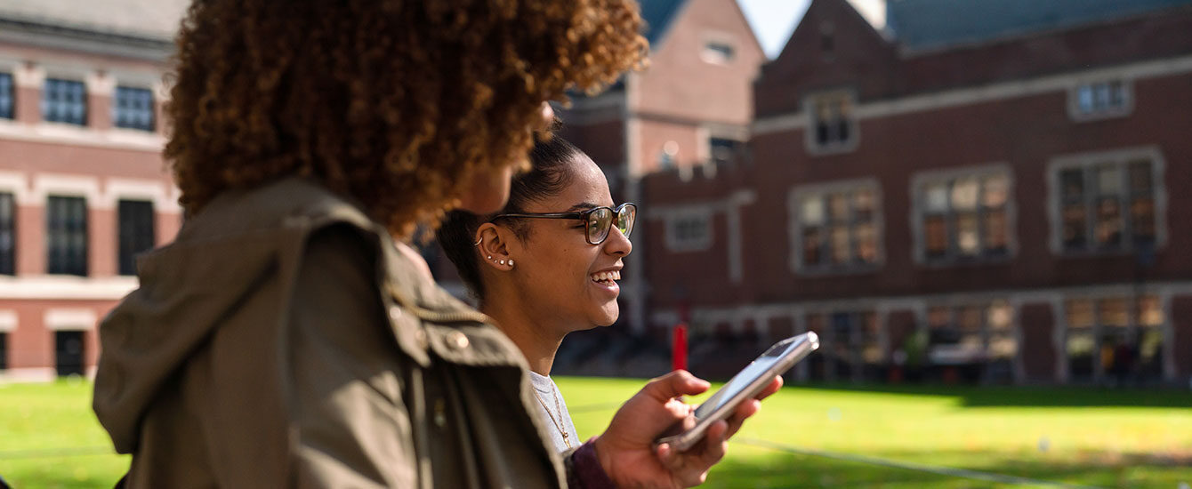 Two students walking on campus