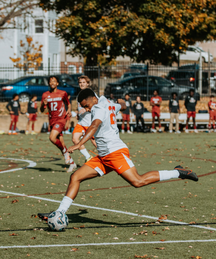 Clark soccer player preparing to kick the ball