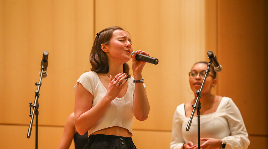 Clark Keys singing in auditorium