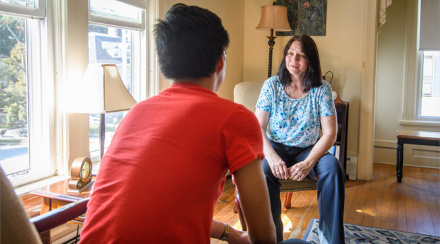Student sitting with counselor