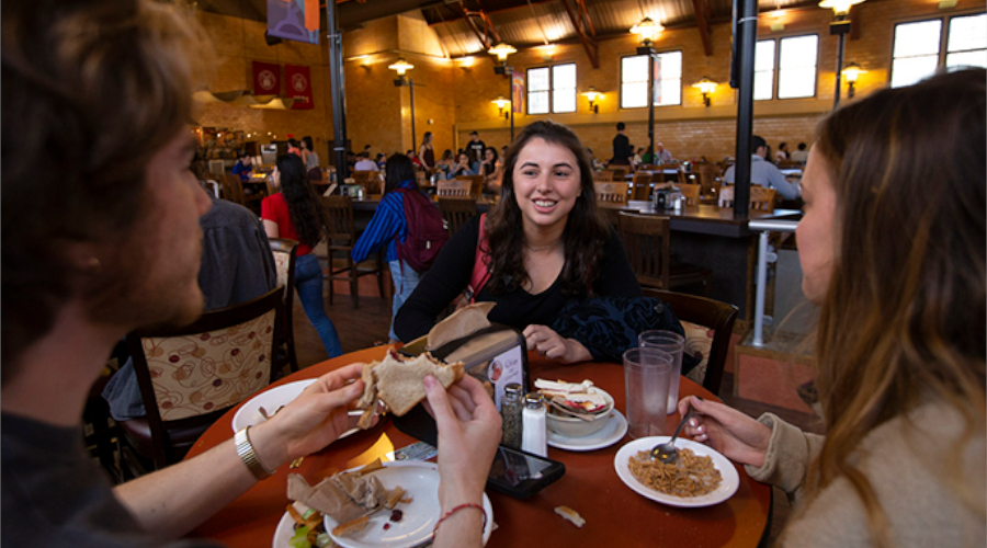 Students eating at table at Higgins Cafe