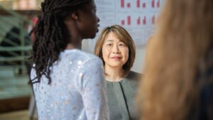 Betsy Huang listens to a student discuss their research during a recent ClarkFest, research showcase