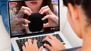 A person viewing asmr content on a laptop