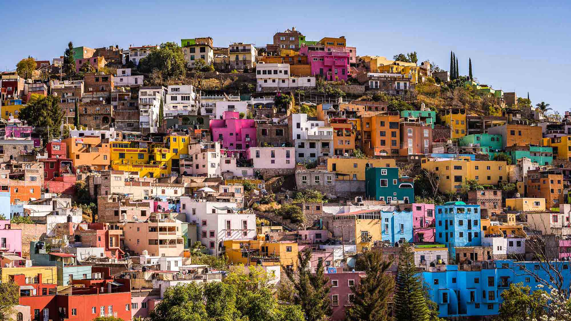 An aerial view of colorful buildings on a hillside in Mexico.