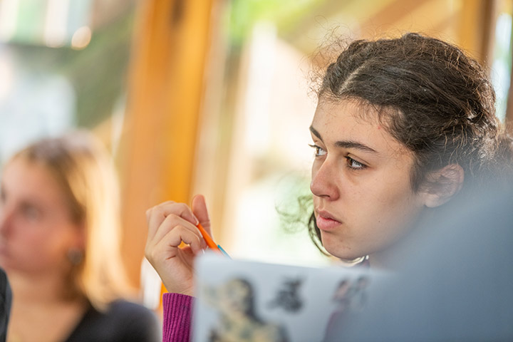 A student listens to the class discussion in a First-Year Intensive class
